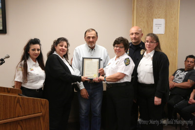 April Lopez, Carol Baca, Valerie Mojica and Christy Marquez along with Police Chief John Garcia accept the Proclamation for National Tele-Communicators week from Commissioner Don Giacomo. 