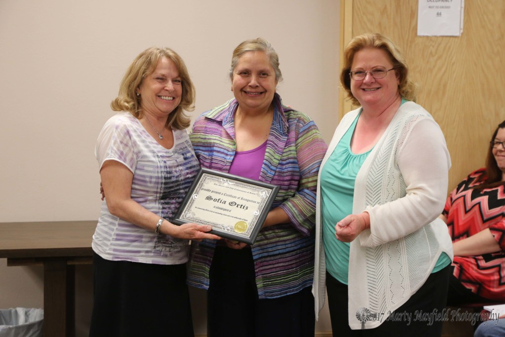 The You Rock Award was presented to Sofia Ortiz for her volunteer efforts at the Chamber and other organizations. She accepts the award from Commissioner Lindé Schuster along with Dee Burks the Chamber Director.