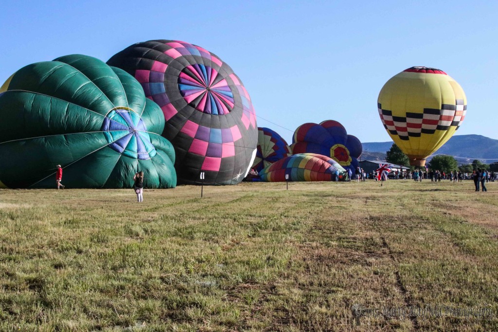 Blue Skies and light winds welcome the crowds to the 2017 balloon rally as balloons fill with air and ready for flight.