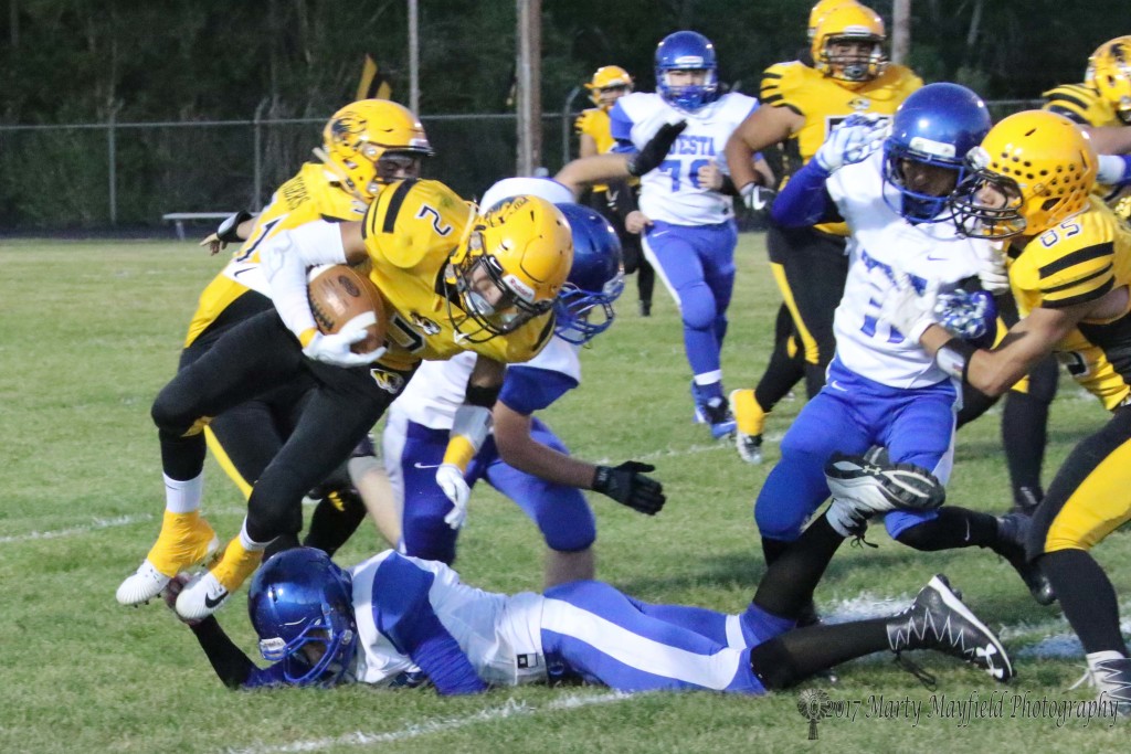Richie Acevedo tries to get the corner turned but gets tripped up by Antonio Garcia early in the homecoming game with Questa Friday night. 