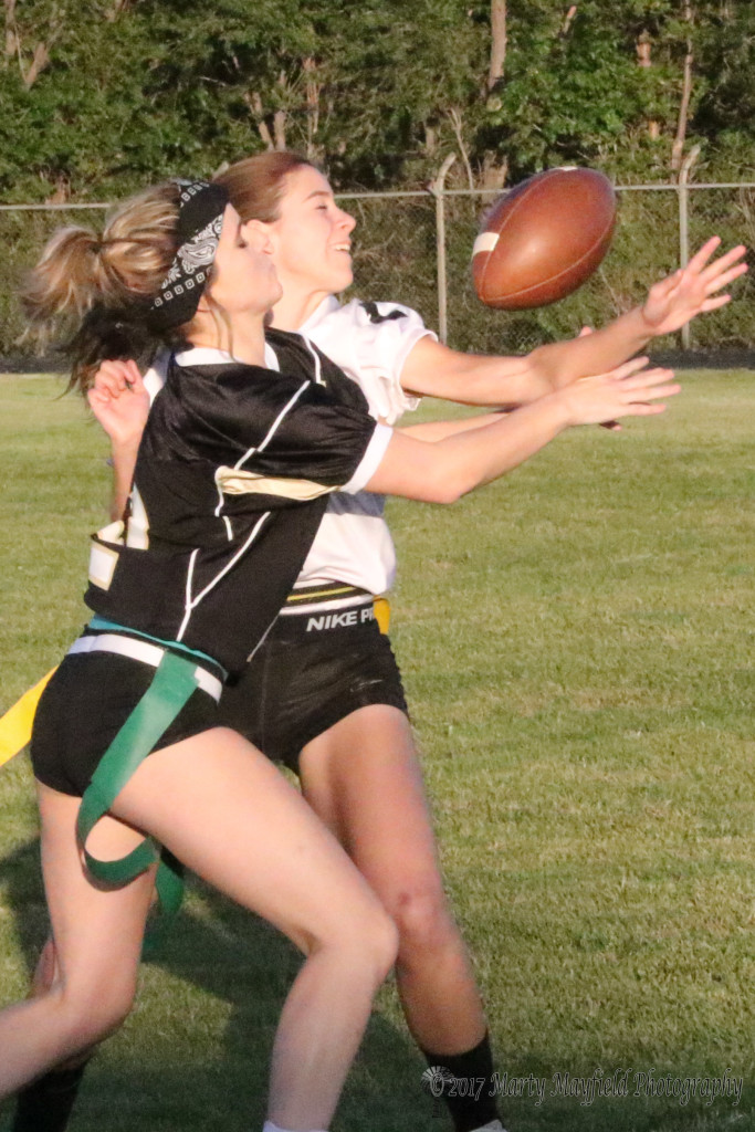 Sr Camryn Mileta and Jr Montan Martinez tangle for the ball during the powder puff flag football game Wednesday evening