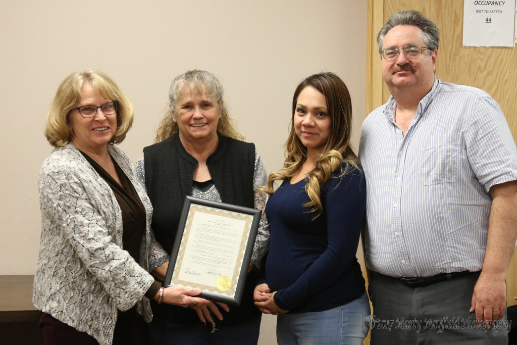 Commissioner Lindé Schuster presented the Proclamation for Domestic Violence Awareness Month to Janis Stuart, Victoria Gonzales and Lee Phillips.