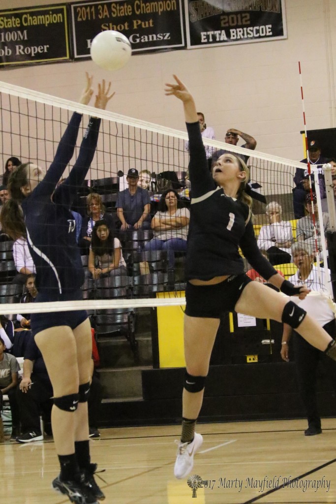 Camryn Mileta gets the ball up and over as Selma Flint goes up for the block. 