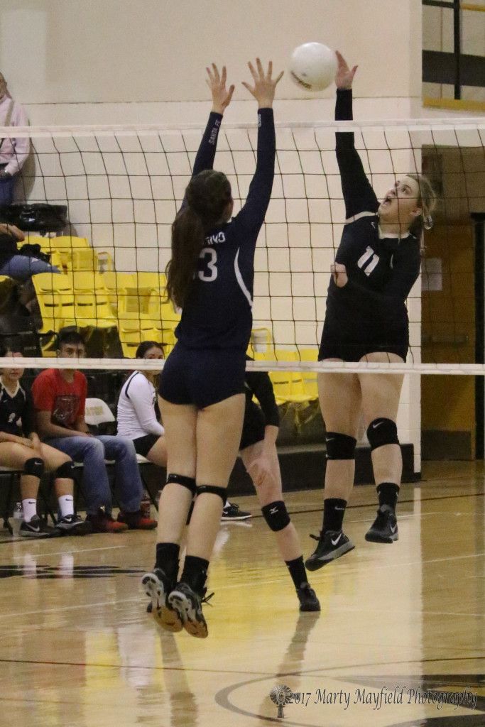 Kerrigan Weese gets the spike as Selma Flint goes up for the block late in game three of the match with Santa Fe Prep in Tiger Gym Saturday afternoon.