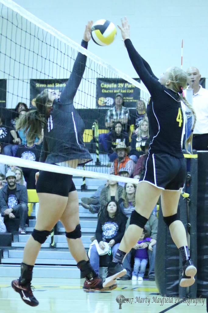 Katy Scott and McKenna Hittson meet at the net once again as the two battled during the District Championship Match in Des Moines Saturday evening. 