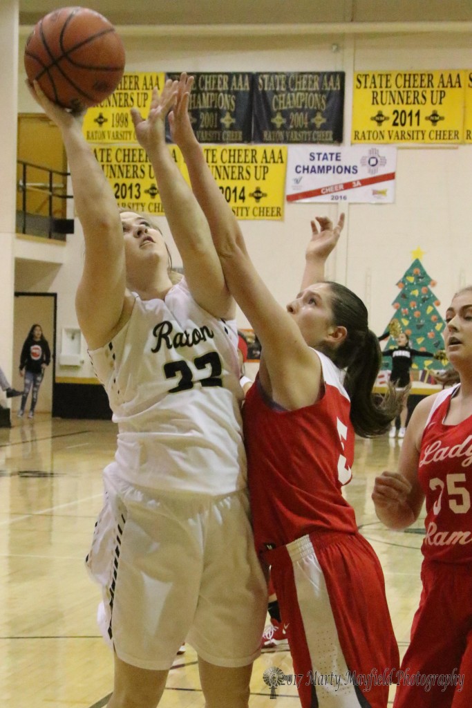 Zoe Salazar reaches up for the block as Kerrigan Weese takes the shot Friday night during the 2017 Cowbell Tourney in Raton.