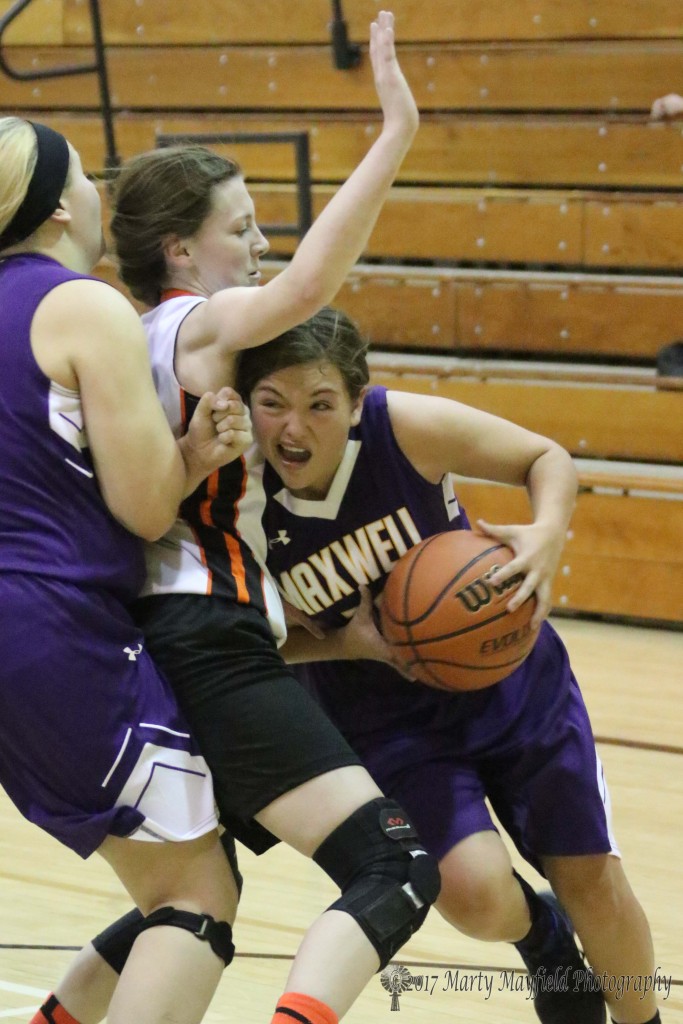 Shiann Weisdorfer set the screen on Jaide Walker while Alexi Hoy drives around her to head to the basket during the 2017 Cowbell Tourney Saturday morning in Tiger Gym.