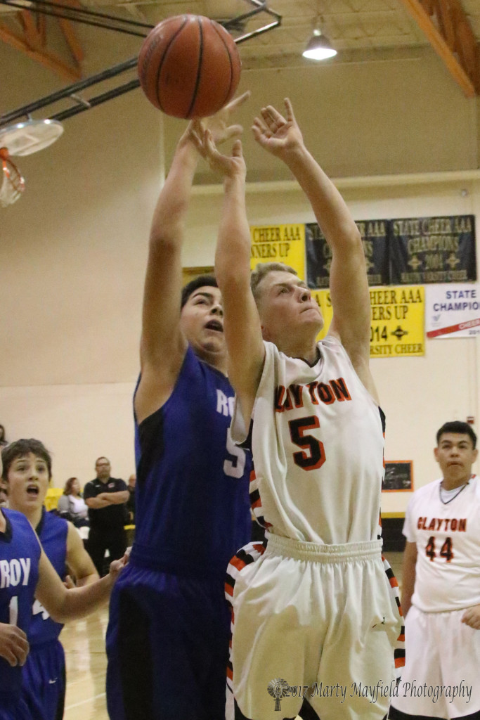Its a battle of the fives as Clayton's Dustin Poling goes up for the shot as Koen Overberger gets a hand on the ball at the 2017 Cowbell Tourney in Raton Saturday morning. 