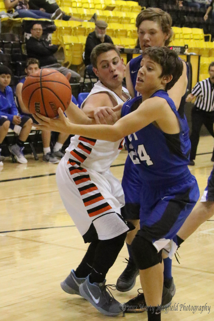 Geo Swagerty gets a hand on Matthew Libby as he tries to make a move with the ball Saturday morning during the consolation game at the 2017 Cowbell Tourney.