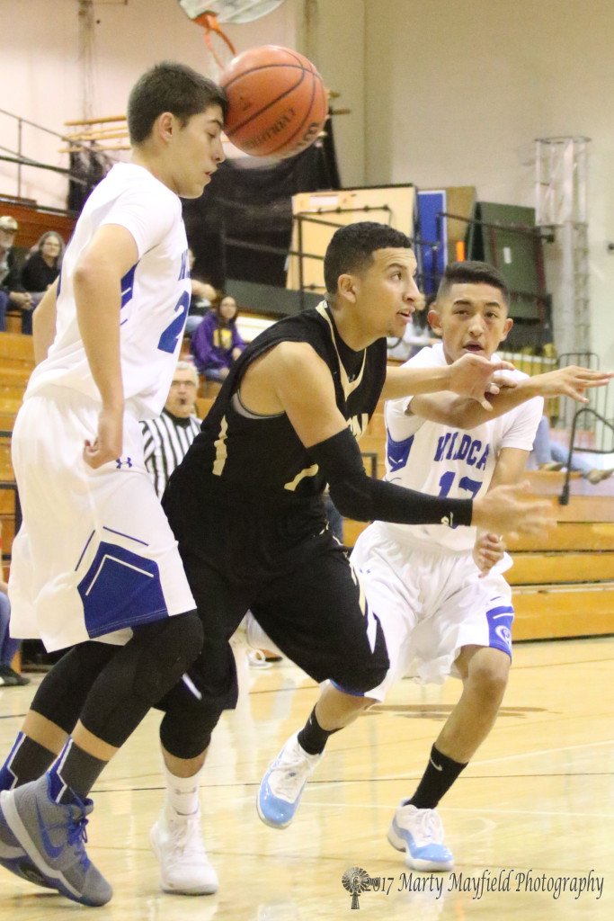 Richie Acevado looses the ball as Gabe Hernandez got a hand on the ball but it was Jonathan Rivera who made the pass during the 2017 Cowbell Tourney consolation game in Tiger Gym Saturday afternoon.