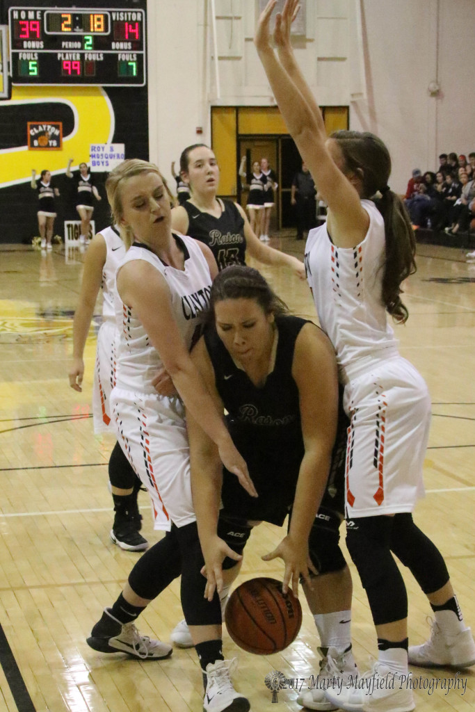 Abby Lawerence and Hannah Johnson crowd Sydni Silva as she tries to grab the ball Saturday evening during the girl's championship game of 2017 Cowbell Tourney in Raton.
