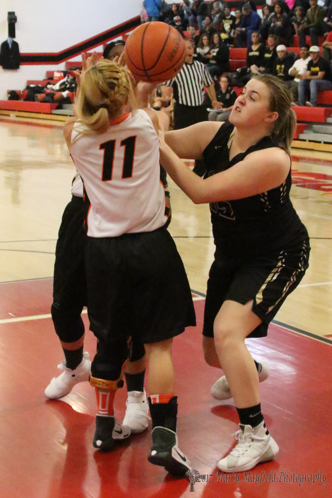 whoops there goes the ball as Raton's Kerrigan Weese and Clayton's Cassie Gonzalez(11) Maranda Arguello battle for the ball during the 81st Annual Cowbell Tourney in Springer Wednesday evening.