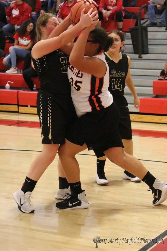 Jadyn Walton and Callie Bates(35) battle for the ball during the 81st Annual Cowbell in Springer Wednesday evening. 