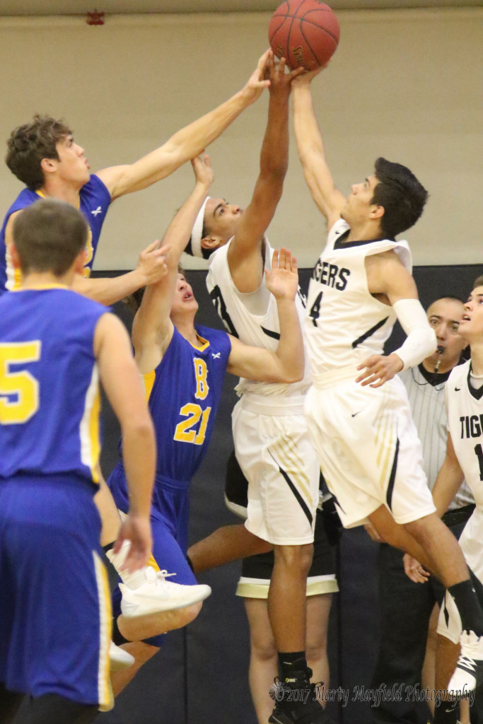 A battle for the rebound as Ethan Martinez and Darien Lewis go head to head with Custer County's David Kinsey and Billy Berry for possession of the ball during the final round of TSJC Tourney action Saturday morning.