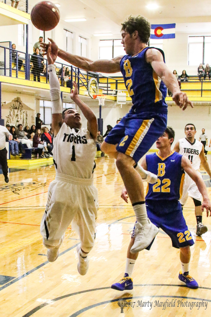 Richie Acevedo(1) goes for the shot only to be rejected by David Kinsey as he get up well above Acevedo during the final round of 2017 TSJC Tourney action Saturday morning in Scott Gym. 