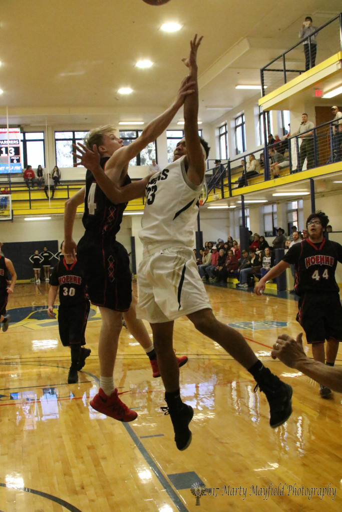 Tristen Molter gets a hand on Darien Lewis as he went up for the lay-up Friday morning in Scott Gym at the TSJC Tourney 