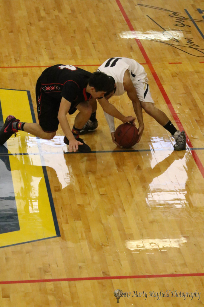 Nicholas Naverette (4) and Dustin Segura (11) go for the close ball Friday morning in Scott Gym. 