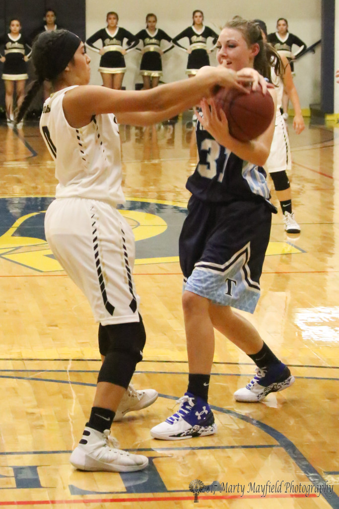Autumn Archuleta and Julia Holden battle for the ball Saturday evening in the 82 Annual TSJC Tourney held in Scott Gym.