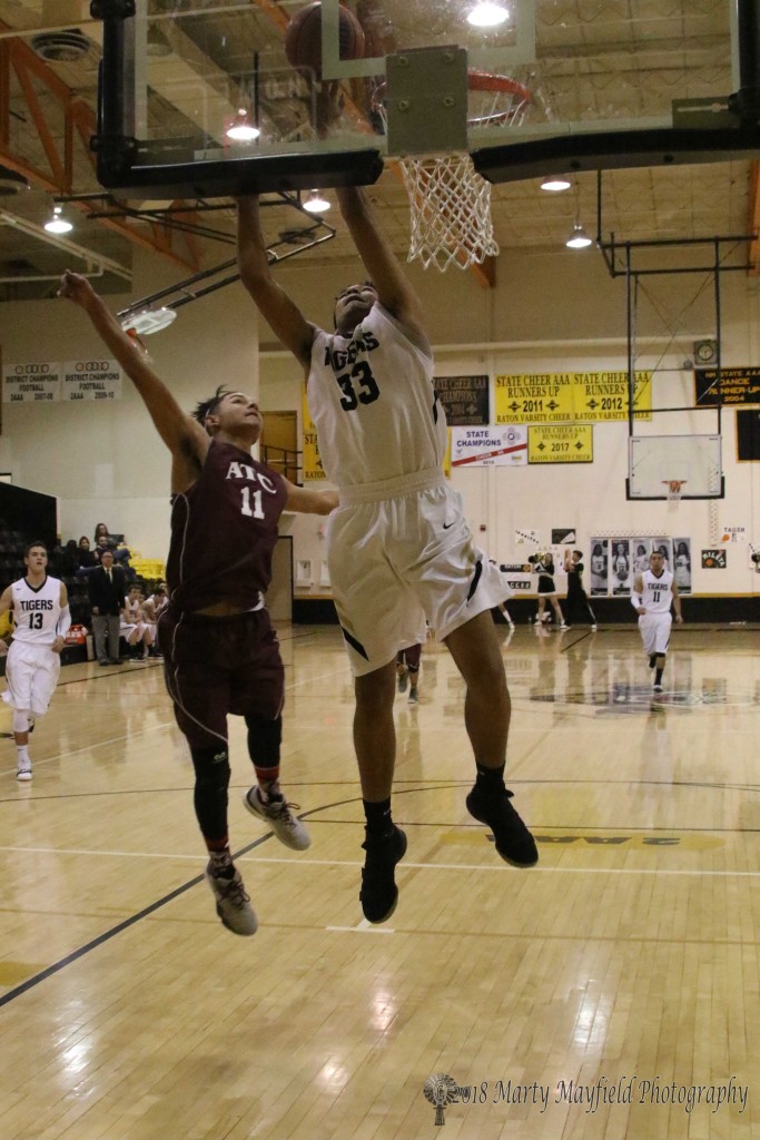 Darien Lewis takes the ball to the hoop as David Prada runs interference Thursday evening during the district tourney game in Raton.