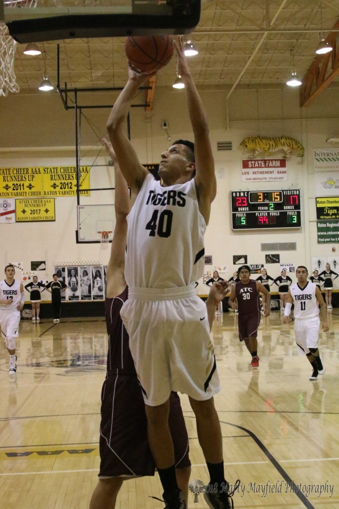 Gabe Martinez takes the ball to the hoop in the second quarter of the district game with ATC Thursday evening. 