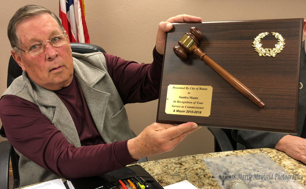 Commissioner Ron Chavez holds up the plaque that commissioners had ready for Mayor Mantz last meeting with the commission.