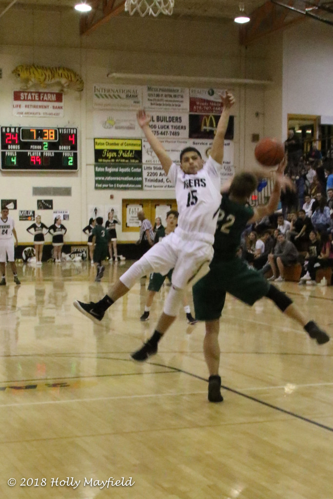 Isaiah Samora and Damien Brown go bang as the pass comes down court during the game Saturday evening.