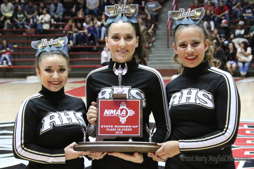 Brianna Marquez, Justine Mascarenas and Gabrielle Sanchez accept the State Runner-Up trophy for 3A Cheer at the 2018 State Spirit competition held in The Pit over the weekend of March 23-24, 2018
