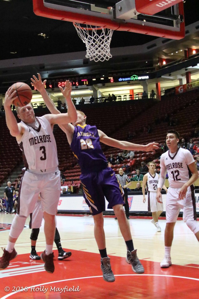 Blake Devaney grabs the ball as he and Kaden Riggs work for the rebound Saturday morning in The Pit during the state title game.