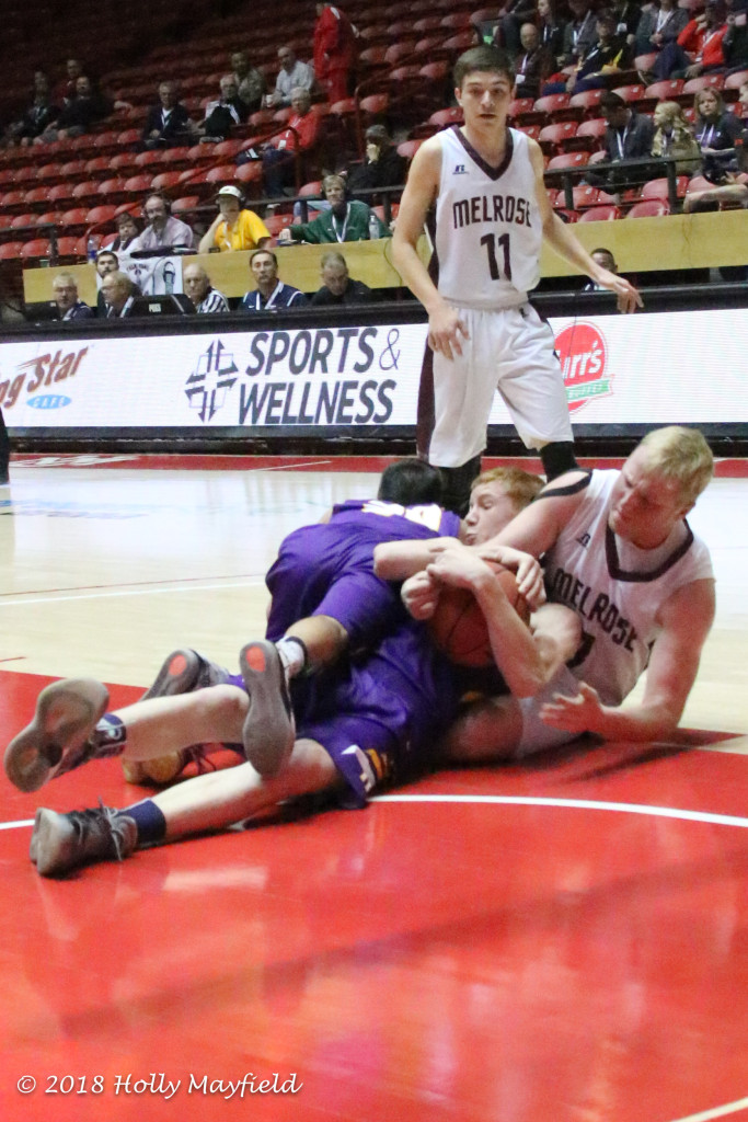 Kaden Riggs and Jeremy Archuleta tangle with Blake Devaney for the ball in this very physical game in The Pit on the UNM Campus in Albuquerque.