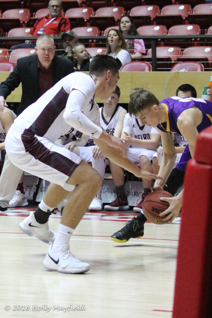 Jordan Jasso reaches in for the take away as Kolton Riggs gains control of the ball and begins to pull it away in this very physical state title game Saturday morning in The Pit. 