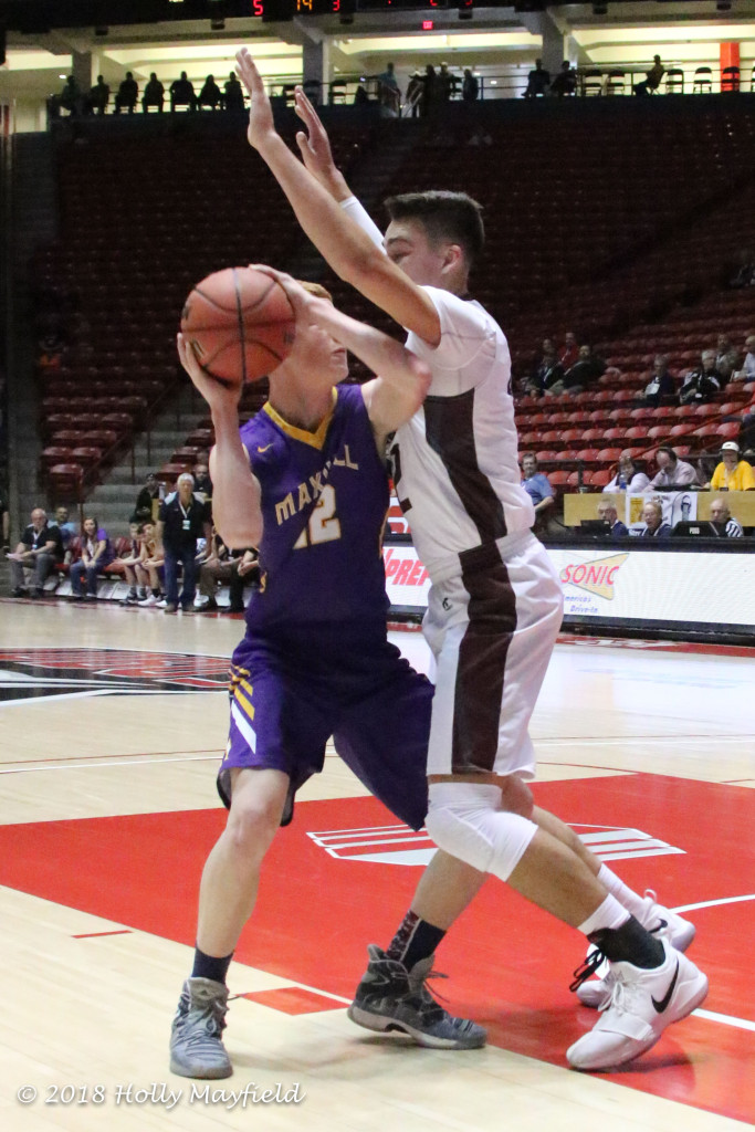 Kaden Riggs looks to go up but finds himself over shadowed by 6' 6" Jordan Jasso Saturday morning in The Pit in Albuquerque.