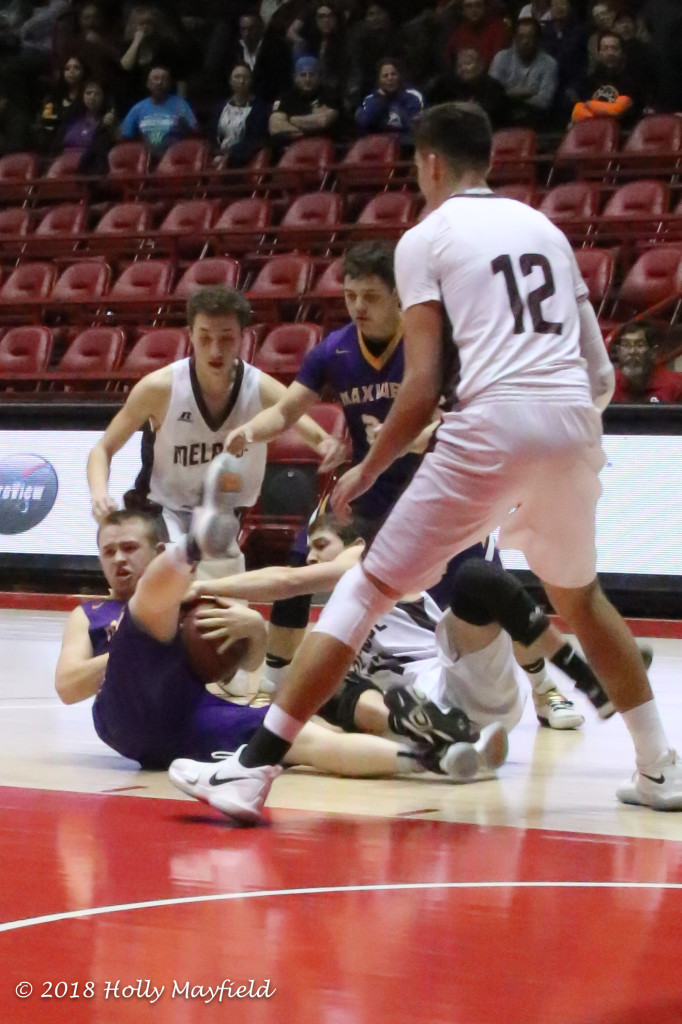 As happened often in this state title game there was a scramble for the ball, here Wesley Jeffery and Tristen Sena struggle for the ball that eventually gets loose and goes out of bounds during the state championship game in The Pit.