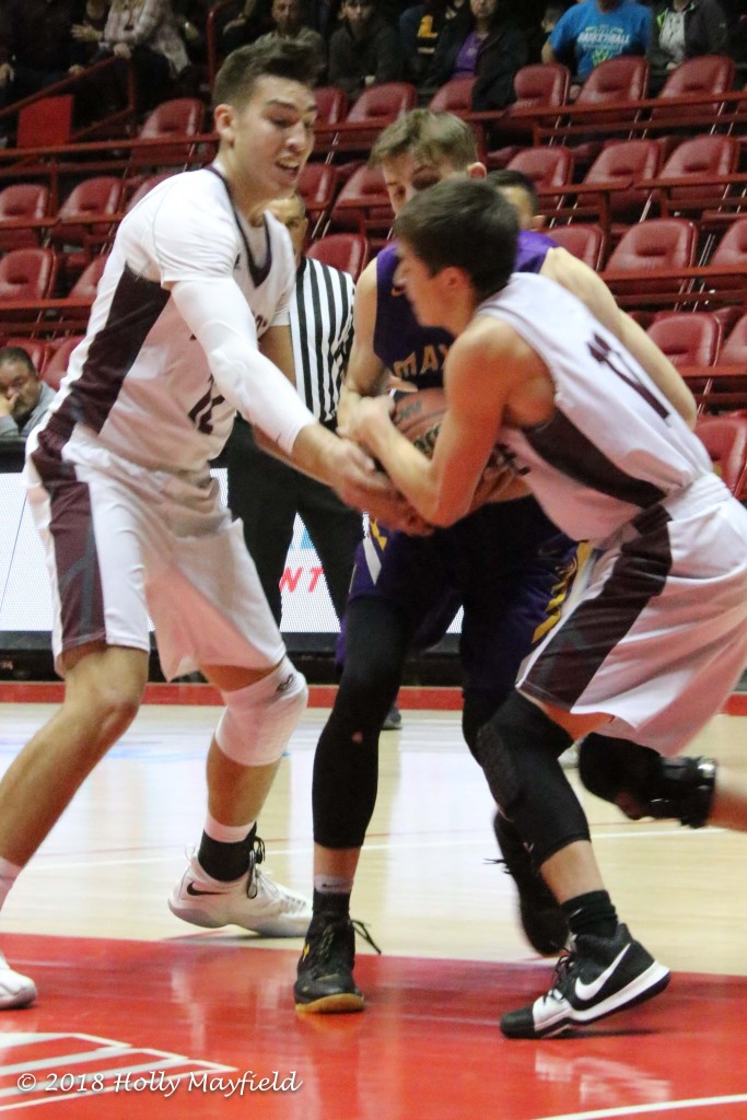 Jordan Jasso and Sterling Sena grab for the ball as Kolton Riggs struggles to keep a hold on it. 