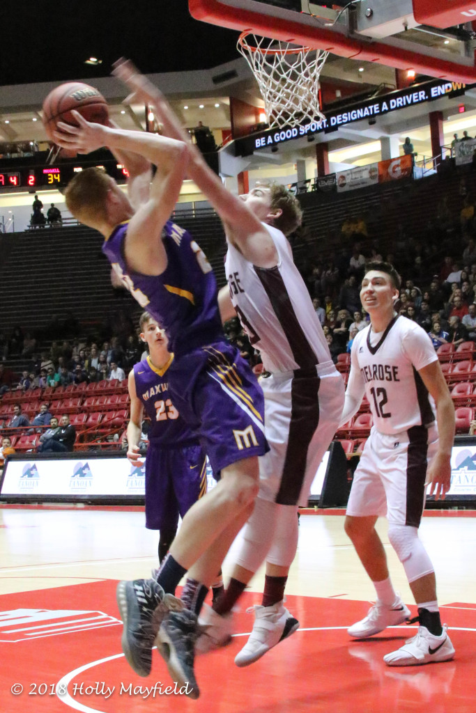 Hunter Sorgen slaps at the ball as Kaden Riggs goes up with the shot during the state championship game in Albuquerque Saturday morning in The Pit. 