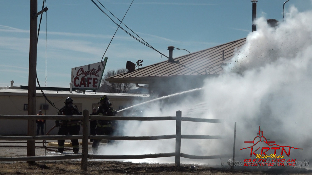 Fire Fighters spray water on the storage shed fire behind the old Pizza Hut building Monday afternoon