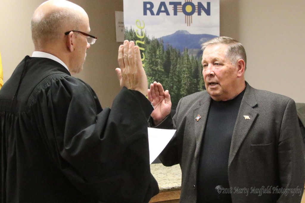 Ron Chavez receives the Oath of Office from Magistrate Judge Warren Walton Monday evening at City Hall.