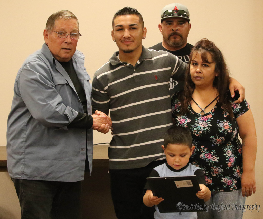 Robert Trujillo was honored with a proclamation for his fighting accomplishments. Commissioner Ron Chavez presented the proclamation to Trujillo and his parents Johnny and Bobby Jean Acevedo, Trujillo's son holds the proclamation.