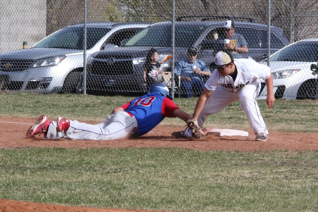 Josh Esquivel just makes it back to first base as Raton Pitcher Cole Medina makes the throw to Jaden Romero at First Base during the game Tuesday afternoon with McCurdy. 