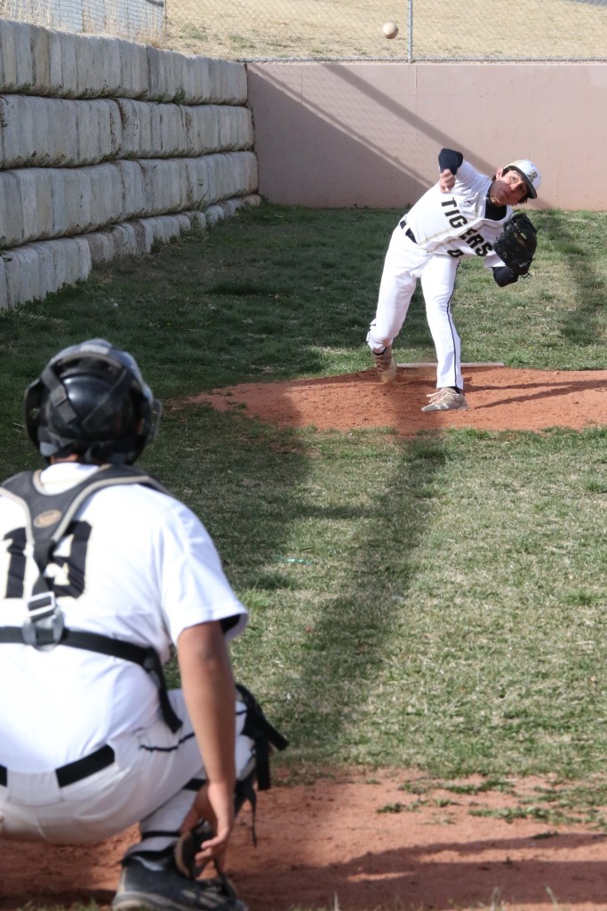 Its late in the game and Dante Romero throws to Branden Decker to warm up. Romero will finish the game against McCurdy for Raton Tuesday afternoon.