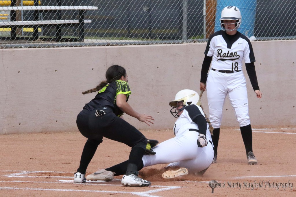 Rato's Jadyn Walton slides in under the ball as Pecos pitcher Melina Herburger attempts the tag at home plate Thursday afternoon at Jim Wade Field.