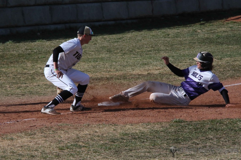 Matt Quarteiri grabs the ball as Austin Gookin slides safe into third base during the game with Rye Colorado Tuesday afternoon. 