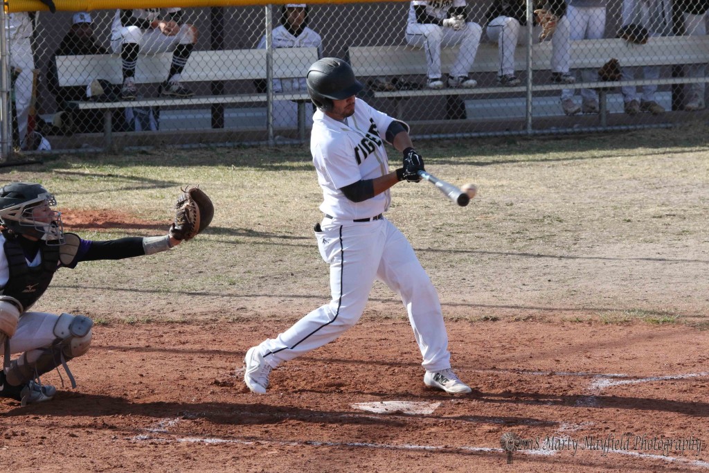 Cole Medina makes contact with the ball and sends it into center field for a double and a score for Raton Tuesday afternoon.