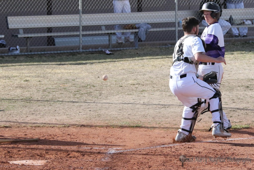 Damon Elarton is met by Robert Horner as the ball goes flying by, Elarton goes on to score another run for Rye Tuesday afternoon.