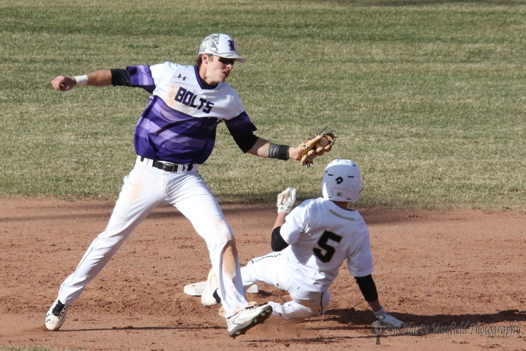 Jasper Hunnicutt steals second as Damon Elarton makes the grab and attempts the tag Tuesday afternoon. 