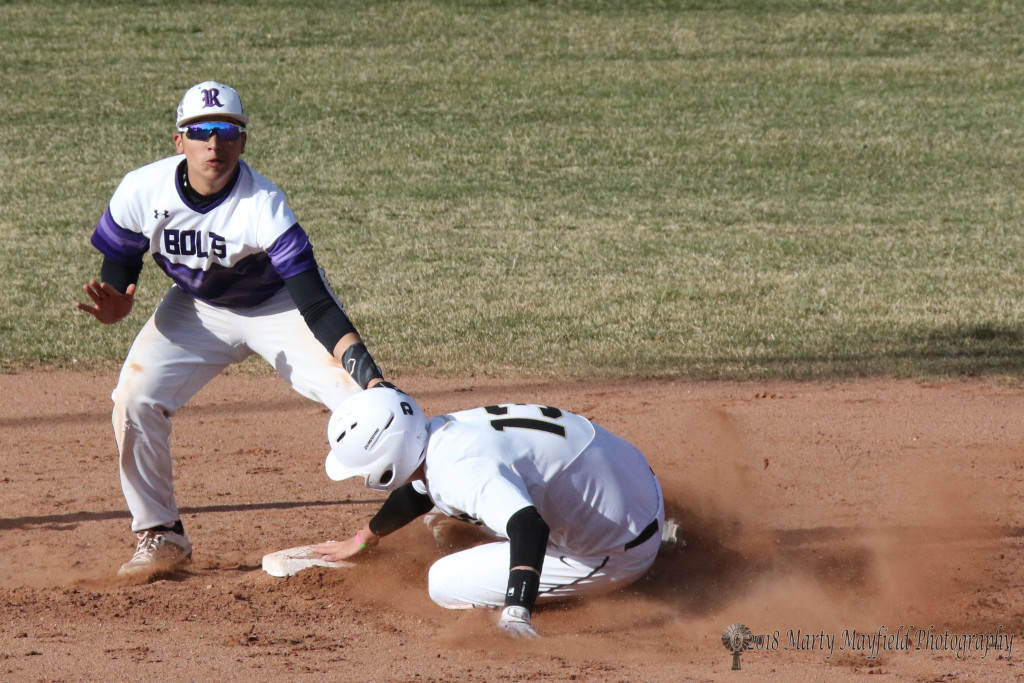 Matt Quarteiri slides in under the tag and is safe at second as Jaxon Ortiz goes for the tag Tuesday afternoon at Gabrielle Field