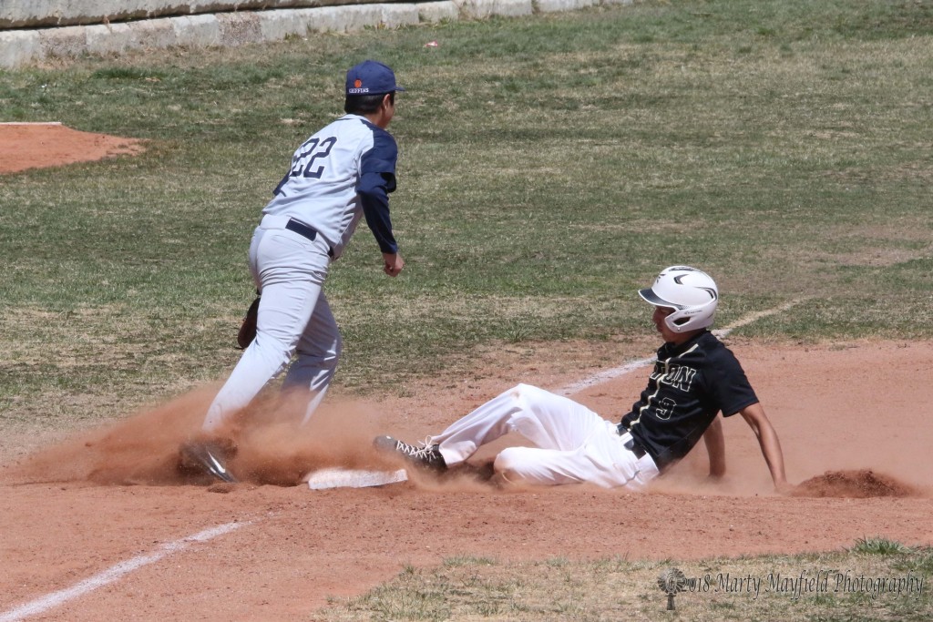 Isaiah Samora slides in safe at third as the Raton boys stole several bases during the double header games with Santa Fe Prep Saturday at Gabrielle Field. 