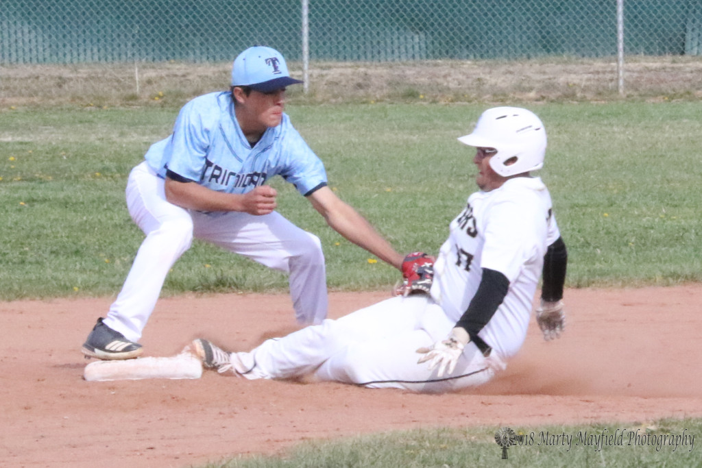 The call was out as William Holland slides into second base and is tagged by Calvin Duran during the game with Trinidad Tuesday afternoon.