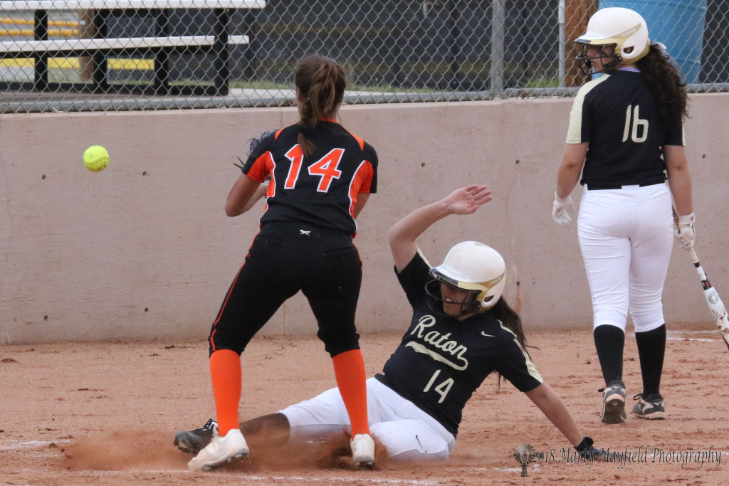 Destiny Garcia slides home and just beats the ball in from the Taos catcher after the pitch from pitcher Kendra Sandoval