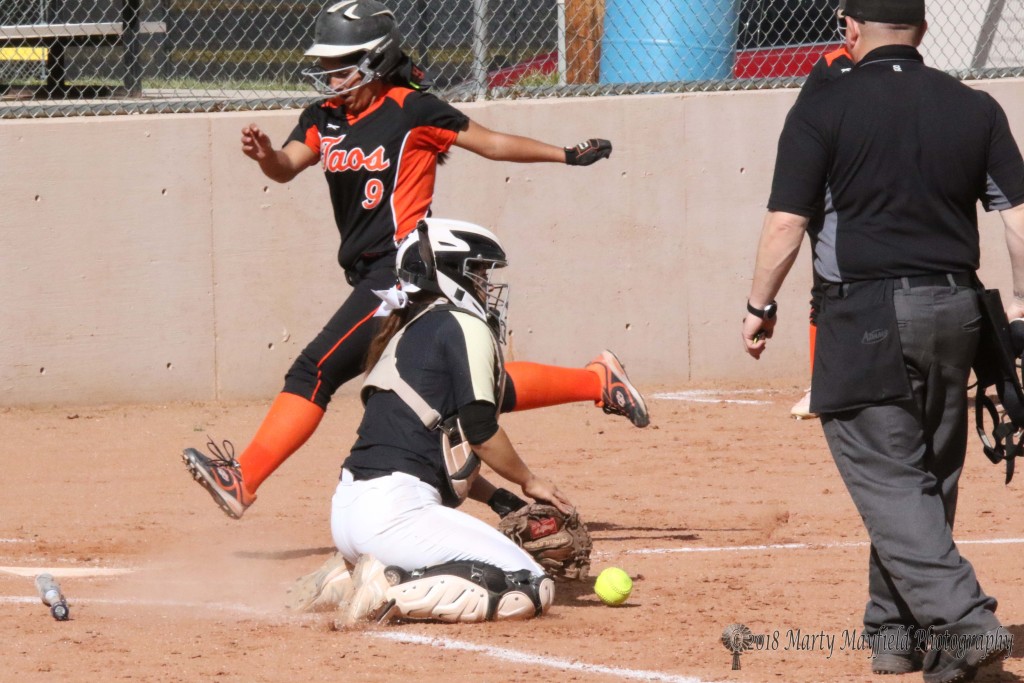 Desiree Martinez beats the ball to home plate as Camryn Stoeker tries to scoop up the ball for the tag Tuesday afternoon at Jim Wade Field