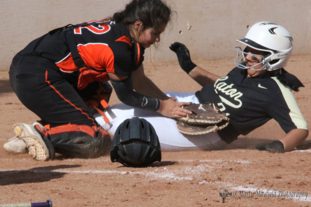 Hailey Flores makes the slide into home plate as the ball gets away from Taos catcher Ariana Aguilar Tuesday afternoon at Jim Wade Field in Raton